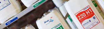 Abstract shot of Activate foodgrade lubricants containers on shelving system